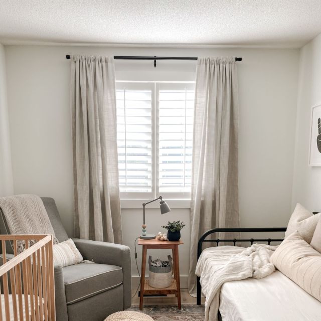 A nursery with a daybed, offering a flexible space where mom and dad can rest while the baby sleeps peacefully.